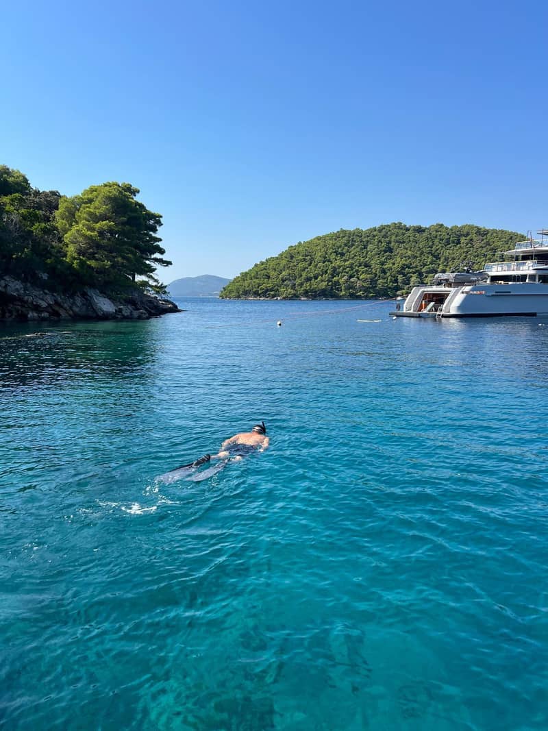 Snorkeling in a calm turquoise bay near Dubrovnik on a private family boat day